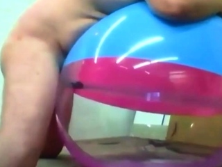 Father Plays with Inflatable Beach Ball bang-out toy