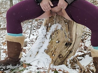 Urinating up against a tree in winter